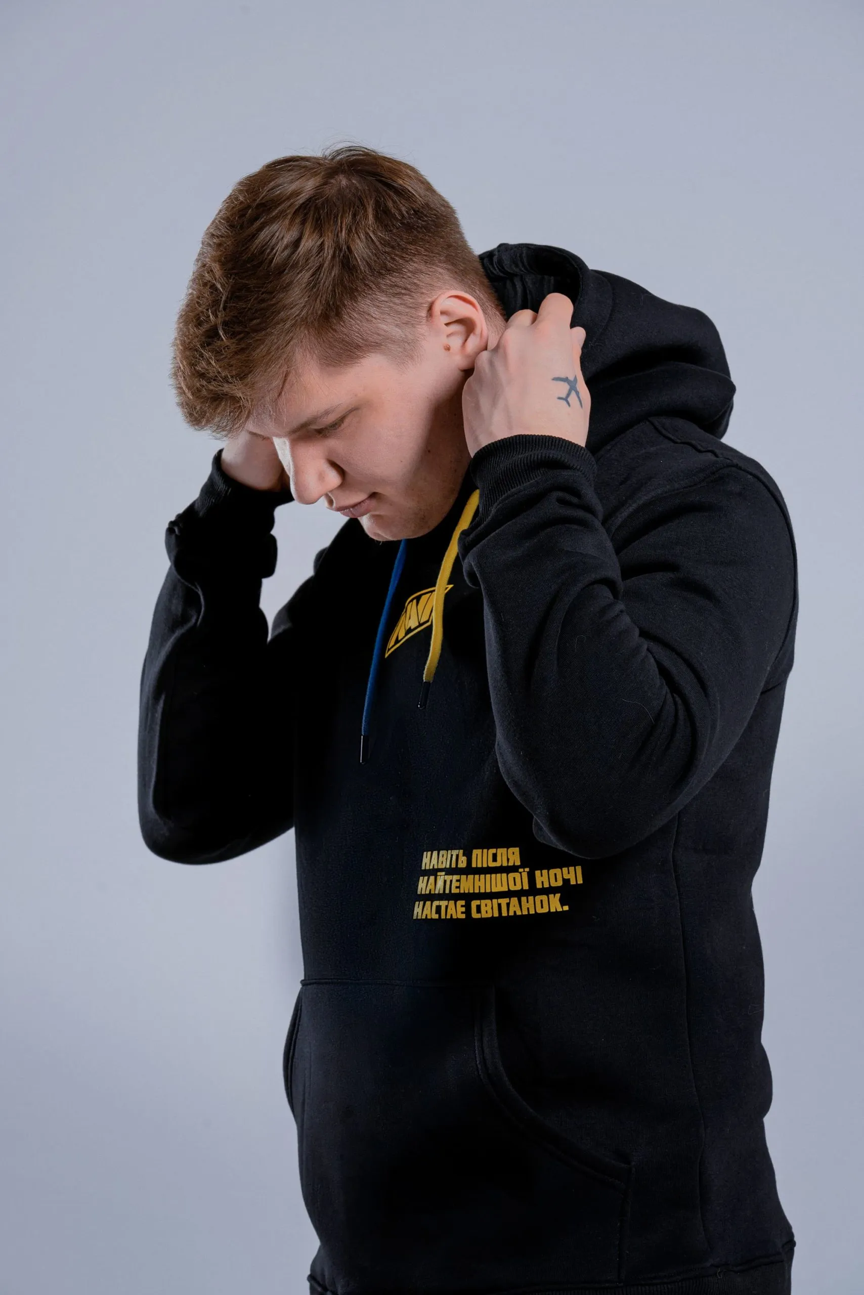 A player in the BIG × NaVi charity hoodie at BIG Studio